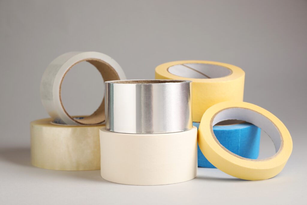 many,rolls,of,adhesive,tape,on,light,grey,background